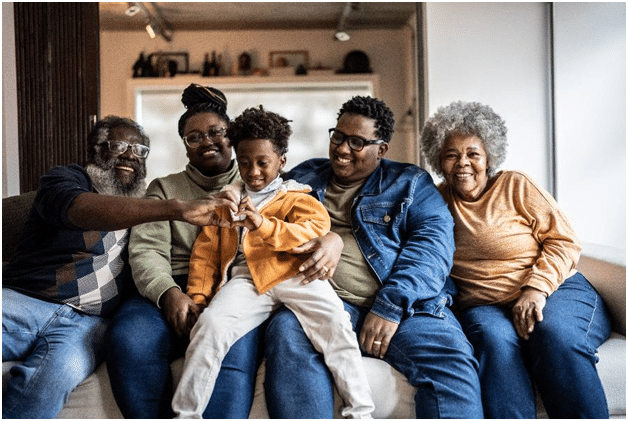 Three generations of one family sit in their home enjoying their hearing health.